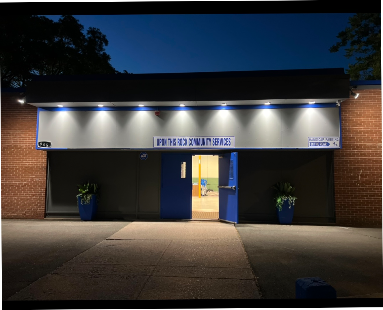 The lit entrance to Upon This Rock Community Services in New Haven, Connecticut
